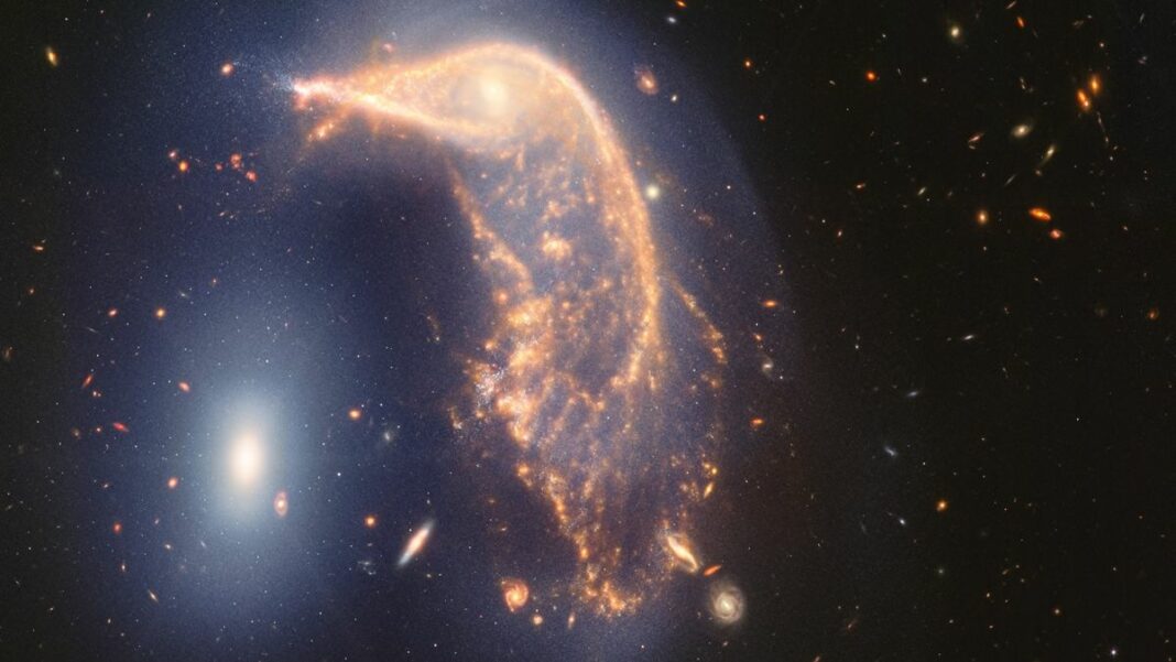 A JWST photo showing a galaxy in the shape of a penguin