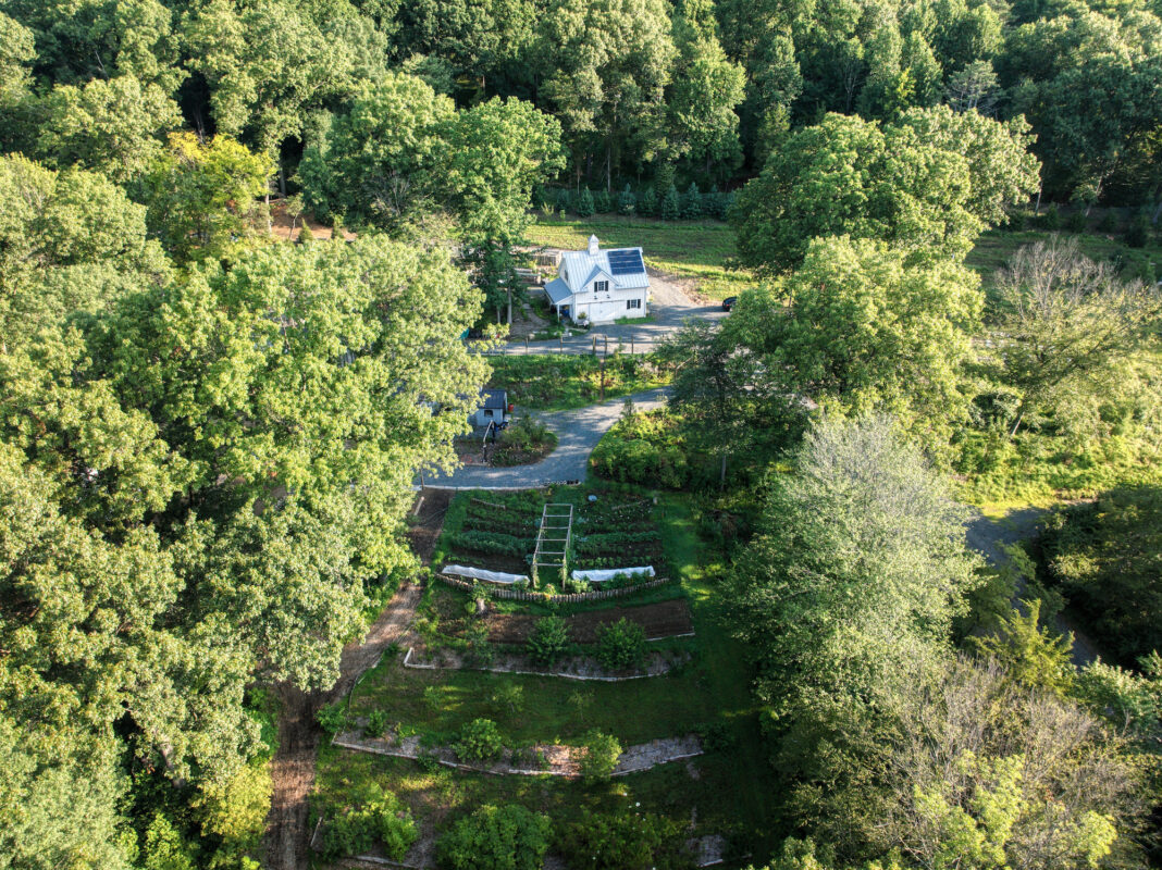 “I love multi-purpose,” says Logan. “I&#8217;m always asking, how do we grow plants that look beautiful and are also edible or serve a purpose like holding the earth and slowing down water.” This overhead view of Maranatha Farm shows the utility barn and Giving Garden North, as well as permaculture terraces and orchard. Photograph by North Jersey Drone Shots.