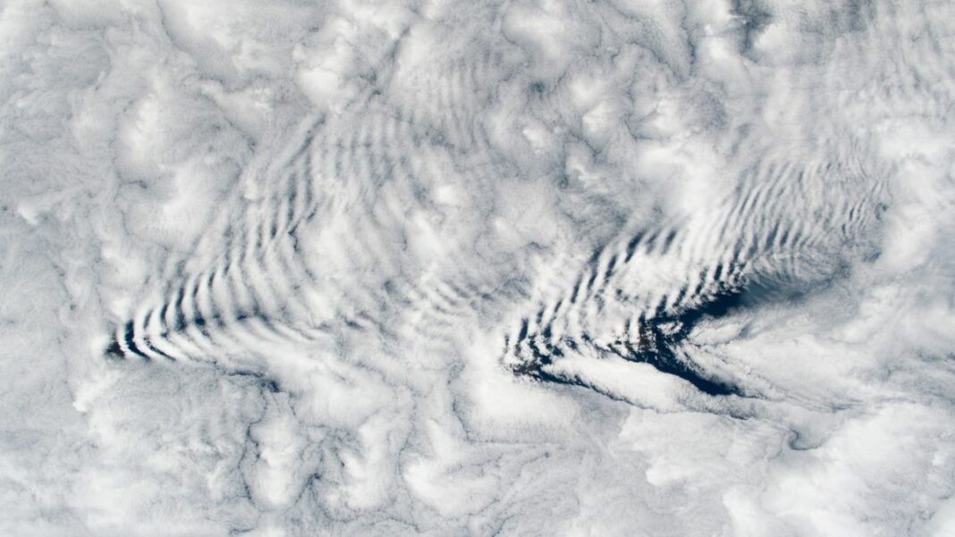 A pair of arrow-shape ripples in clouds as viewed from space